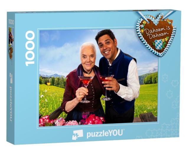 Puzzle 1000 Teile „Dahoam is Dahoam: Uri und Pfarrer Burman“