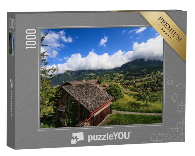 Puzzle 1000 Teile „Alpen mit traditionellen Berghütten und grünen Wiesen“