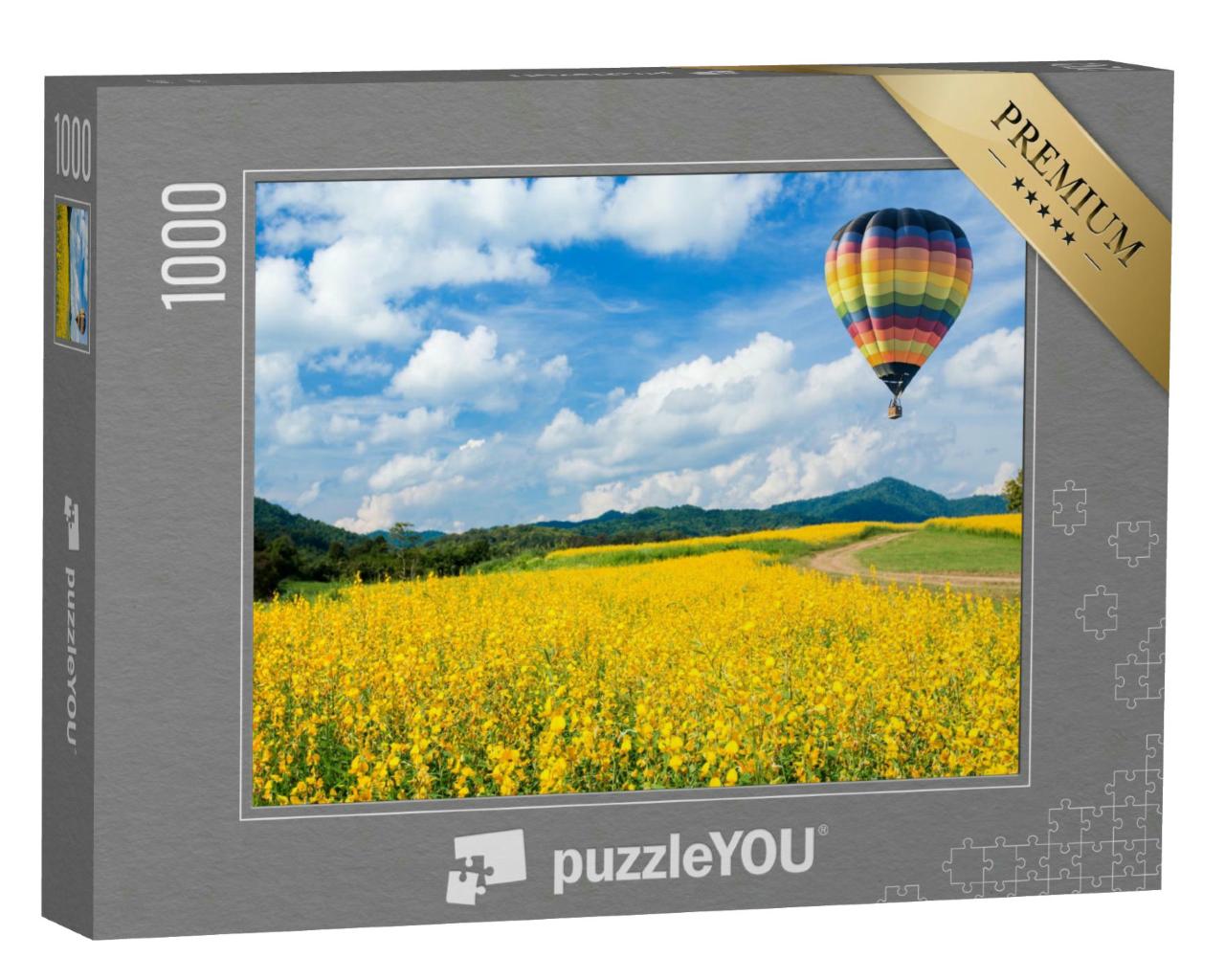 Puzzle 1000 Teile „Heißluftballon über gelben Blumenfeldern, im Hintergrund ein Mittelgebirge “