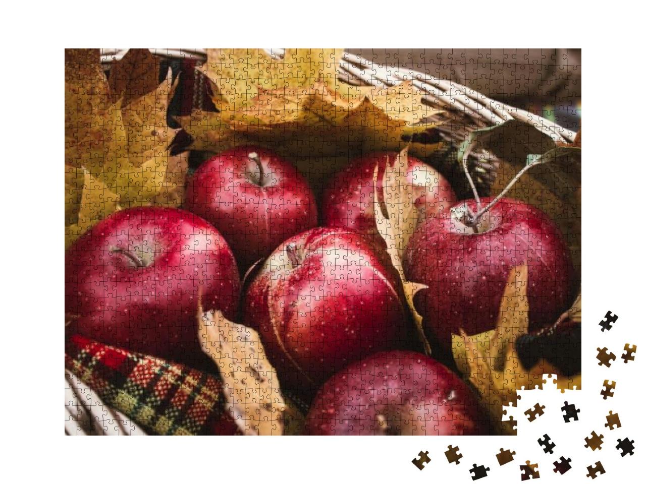 Puzzle 1000 Teile „Ernte von roten Äpfeln in einem Korb voller Herbstlaub“