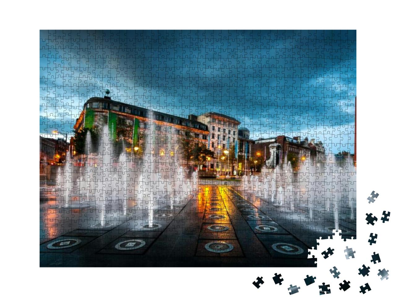 Puzzle 1000 Teile „Springbrunnen im Piccadilly-Garten im Zentrum von Manchester, England“