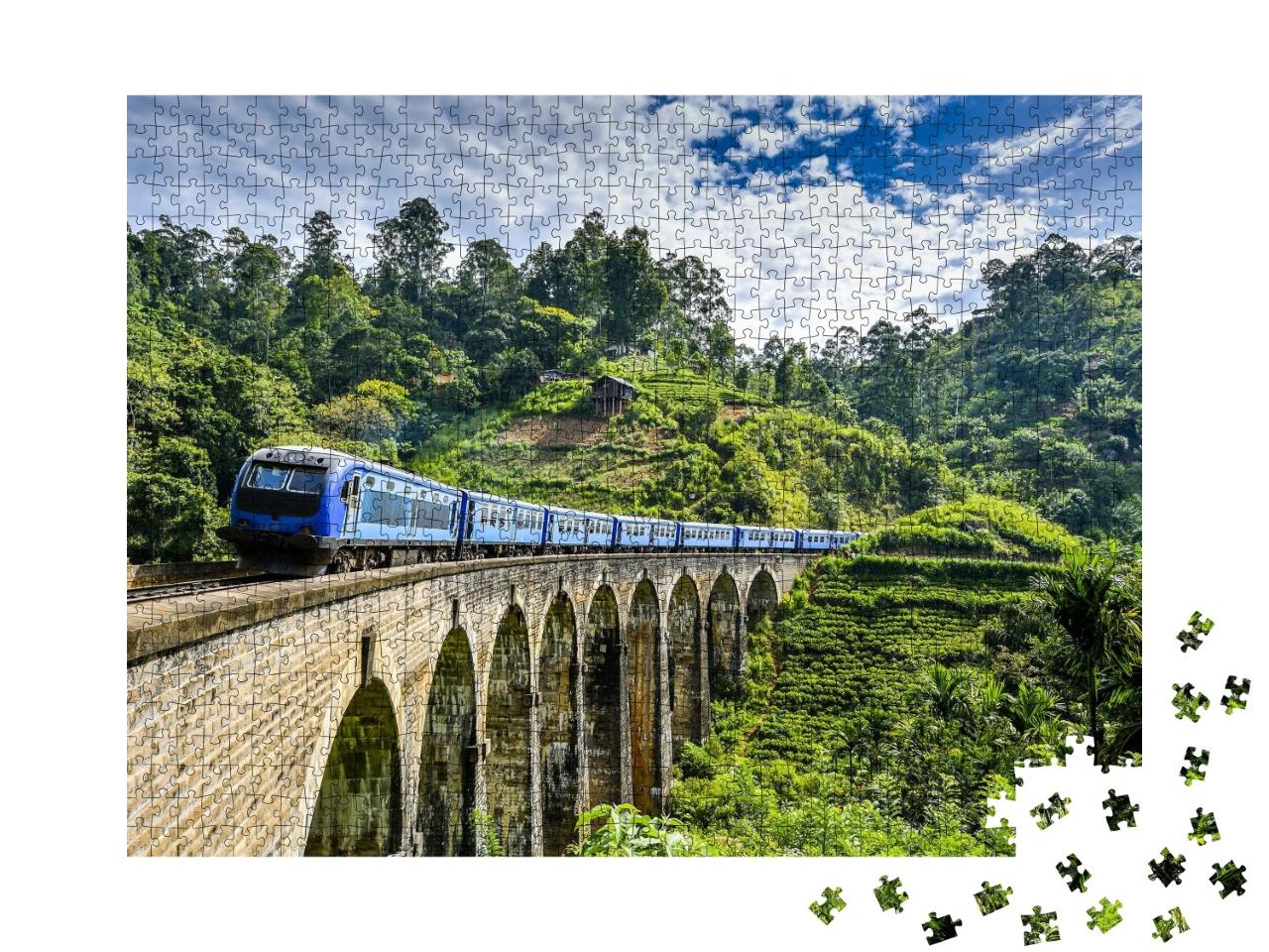 Puzzle 1000 Teile „Eisenbahnbrücke auf grüner Berglandschaft“