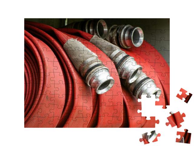 Puzzle 100 Teile „Aufgerollter Feuerwehrschlauch“