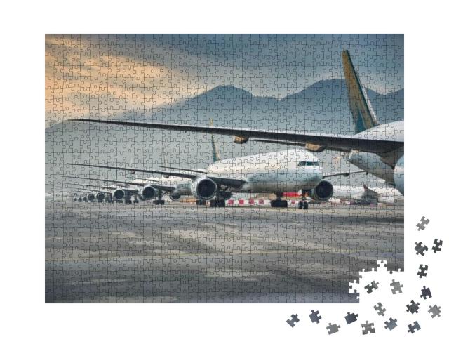 Puzzle 1000 Teile „Geparkte Flugzeugflotte“