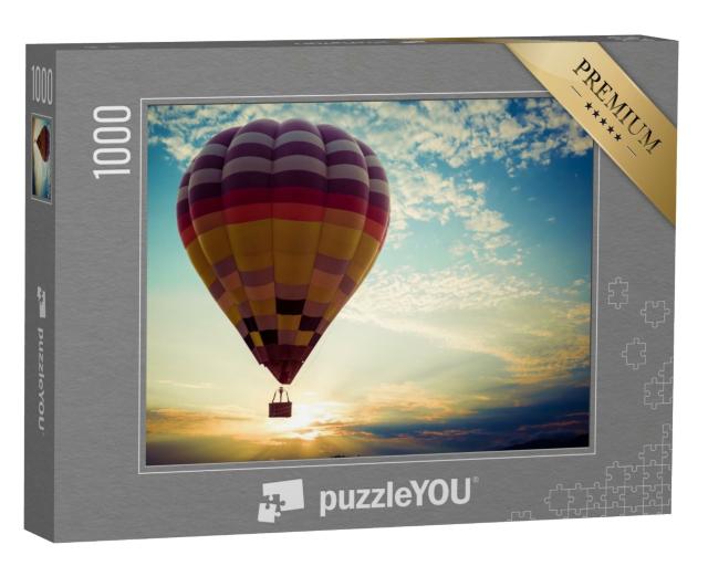 Puzzle 1000 Teile „Bunter Heißluftballon bei seiner Reise in den Sonnenuntergang“