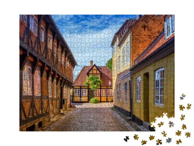 Puzzle 1000 Teile „Straße und Häuser der mittelalterlichen Stadt Ribe in Dänemark“