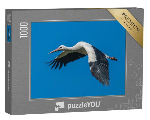 Puzzle 1000 Teile „Fliegender Weißstorch am blauen Himmel“