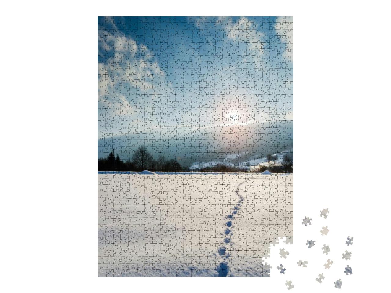 Puzzle 1000 Teile „Spuren im Schnee in den Sonnenuntergang“
