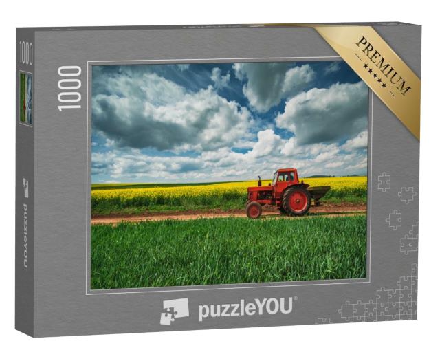 Puzzle 1000 Teile „Roter Traktor mit Anhänger vor einem Rapsfeld, Oxfordshire“