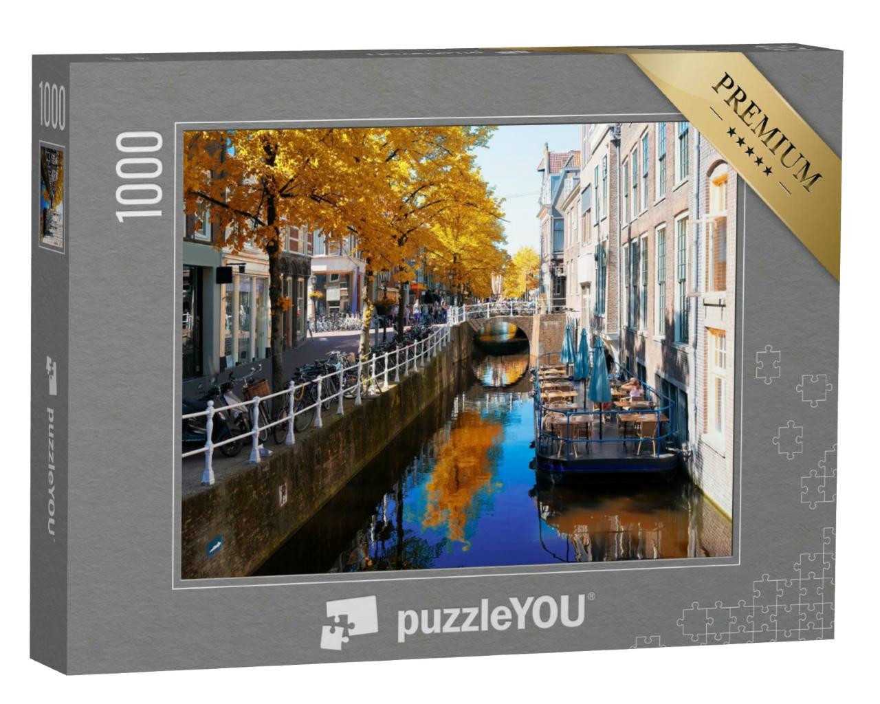 Puzzle 1000 Teile „Herbstliche Straße mit Kanal in der Altstadt von Delft, Niederlande“