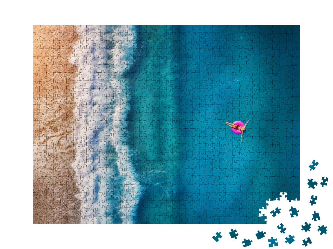 Puzzle 1000 Teile „Luftaufnahme einer Frau auf einem Schwimmring“